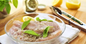 Raw chicken breasts marinating
